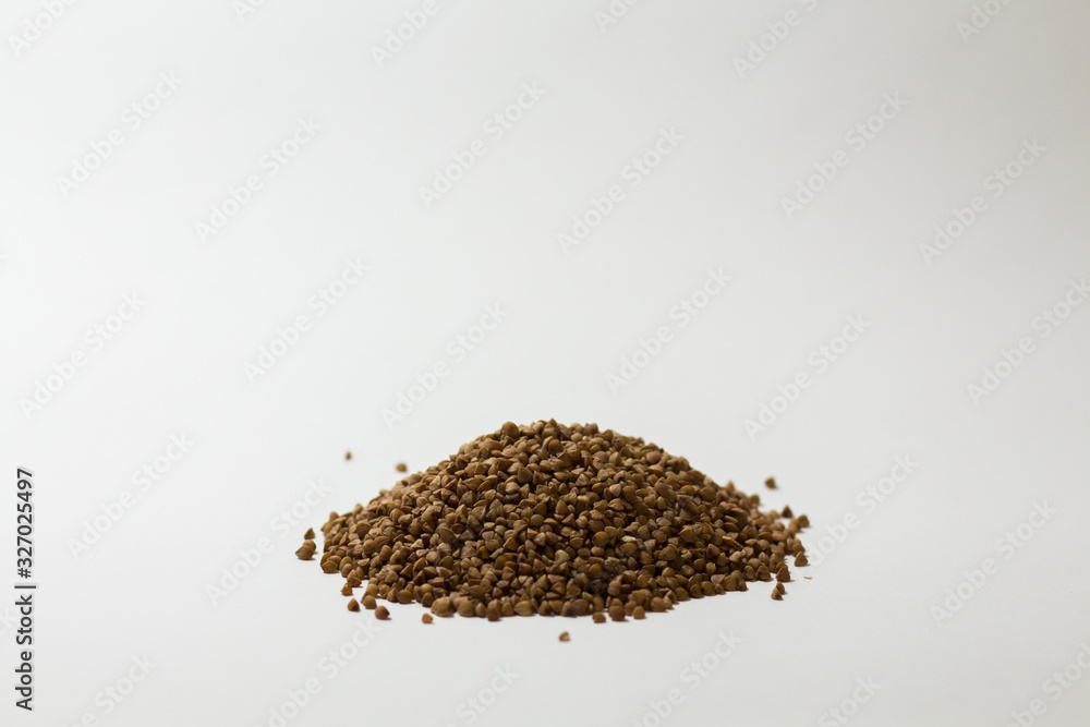 heap of buckwheat on a white background heap of buckwheat on a white background