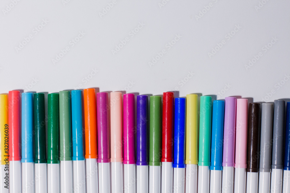 multicolored felt-tip pens on a white background multicolored felt-tip pens on a white background