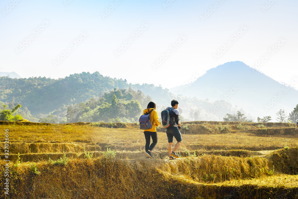 adventure travel from asian couple hiking and walk to the mountain in summer season adventure travel from asian couple hiking and walk to the mountain in summer season