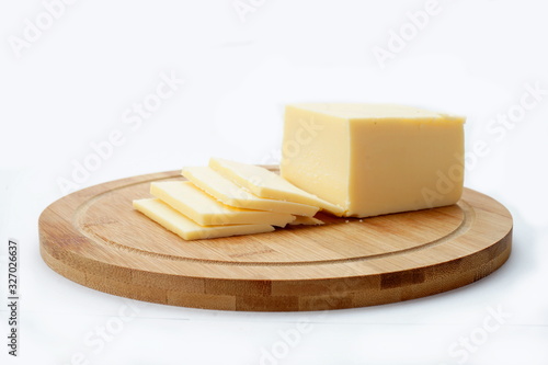Cheese on a cutting Board isolated on a light background