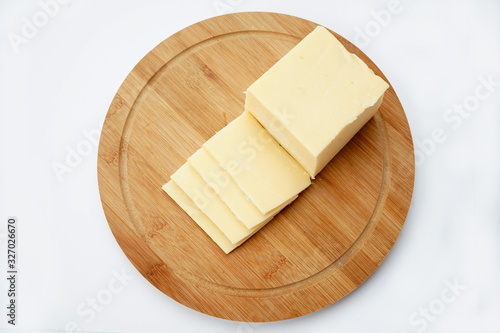 Cheese on a cutting Board isolated on a light background