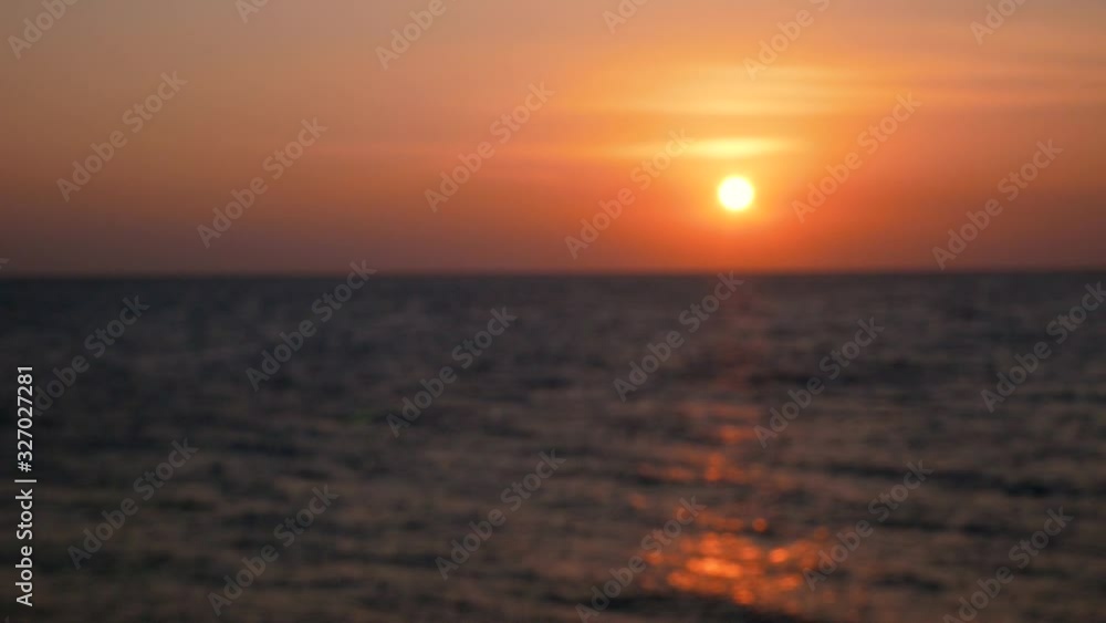 Blurred sunrise on the sea skyline. Deep dark waves on sun rays reflection. Defocused slow motion stock video Blurred sunrise on the sea skyline. Deep dark waves on sun rays reflection. Defocused slow motion stock video