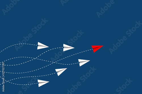 Leadership and competition concept, with red paper plane leading among white on blue background.