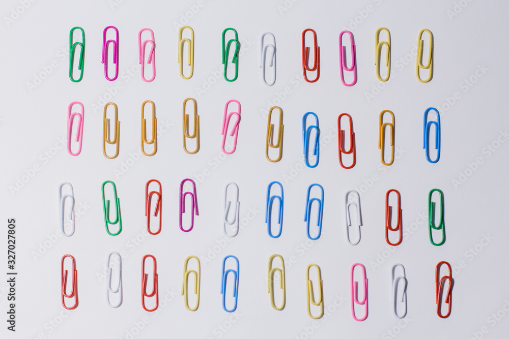 multicolored paper clips on a white background multicolored paper clips on a white background