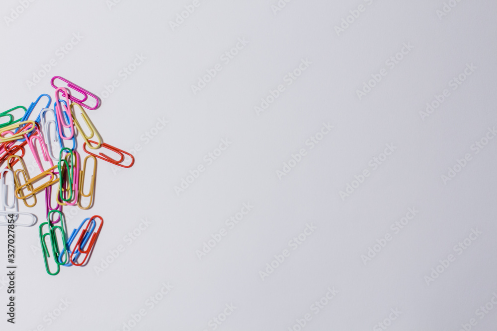 multicolored paper clips on a white background multicolored paper clips on a white background