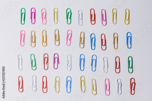 multicolored paper clips on a white background