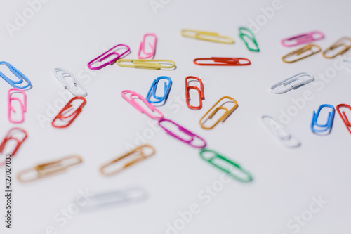 Bild auf Leinwand multicolored paper clips on a white background