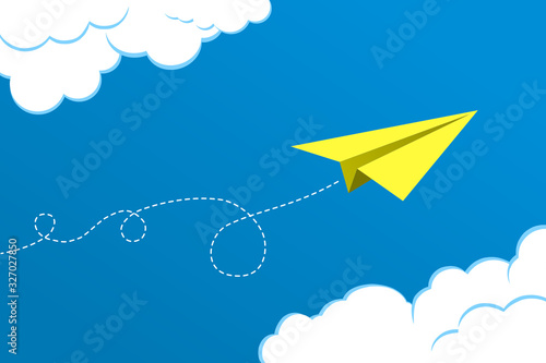 Yellow paper plane flying on blue sky background