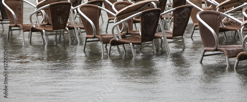 many brown chairs of a venetian alfresco cafe with water © ChiccoDodiFC
