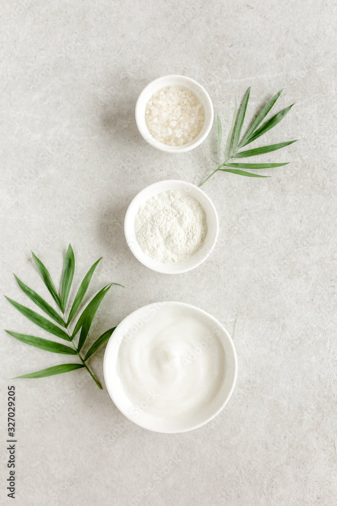 Three various natural spa cosmetics products in a bowl: facial cream, cosmetic clay, sea salt on gray marble background. Skincare concept. Beauty blogger, salon treatments concept. Flat lay, top view Three various natural spa cosmetics products in a bowl: facial cream, cosmetic clay, sea salt on gray marble background. Skincare concept. Beauty blogger, salon treatments concept. Flat lay, top view