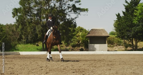 Caucasian woman riding her dressage horse