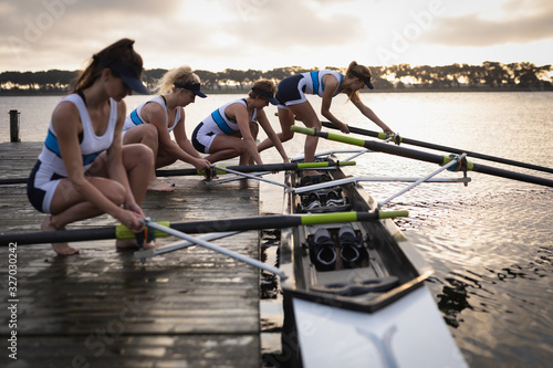 Female rowing team training on a river photo