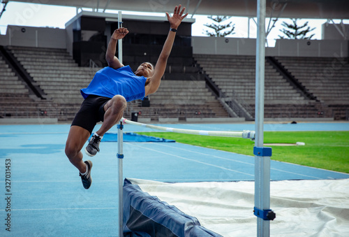 Athlete doing a high jump photo
