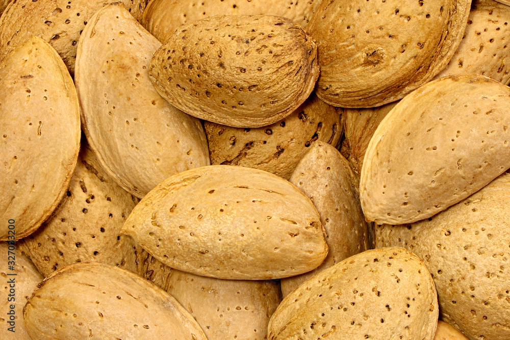 Almonds in their shell texture,pattern background. Almonds raw. Almonds in their shell texture,pattern background. Almonds raw.