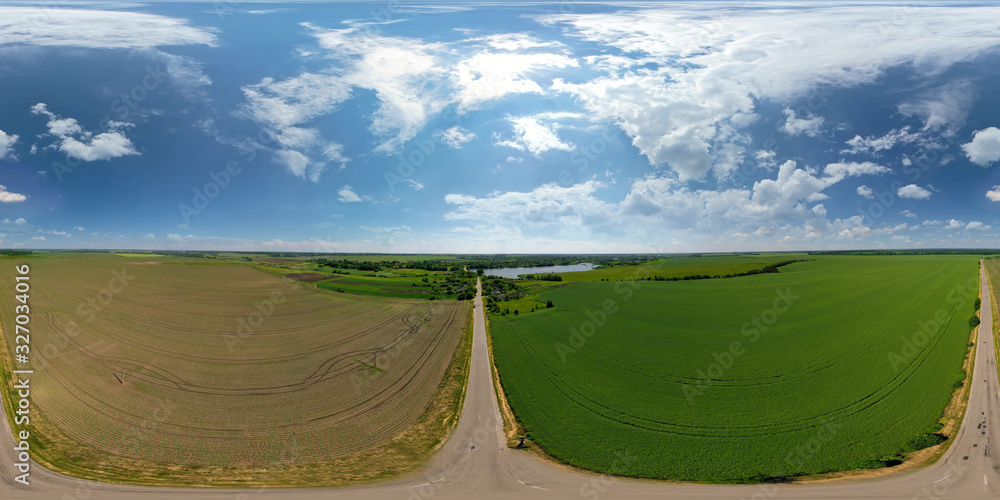 Summer nature field sky landscape. Summer nature field view.. Landscape of green and brown field. Farmland and road. Beautiful blue sky with big clouds