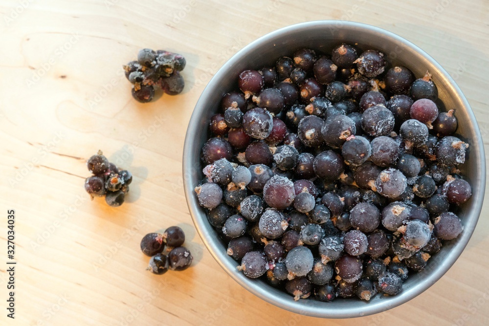 Frozen black currant in a bowl Frozen black currant in a bowl
