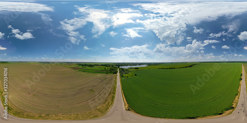 Summer nature field sky landscape. Summer nature field view.. Landscape of green and brown field. Farmland and road. Beautiful blue sky with big clouds photo