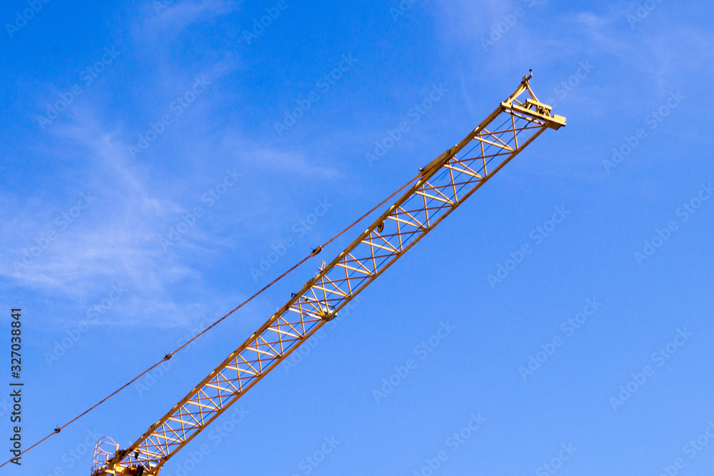 arrow of a construction crane in the blue sky arrow of a construction crane in the blue sky