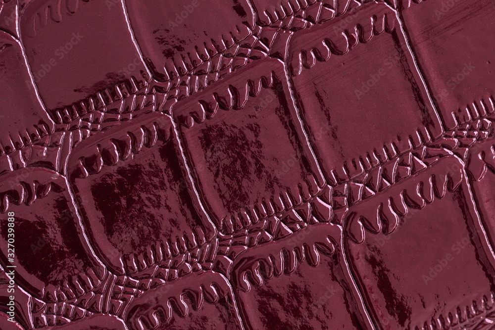 Φωτογραφία Texture of genuine leather close-up, embossed under the skin of reptile, burgundy color