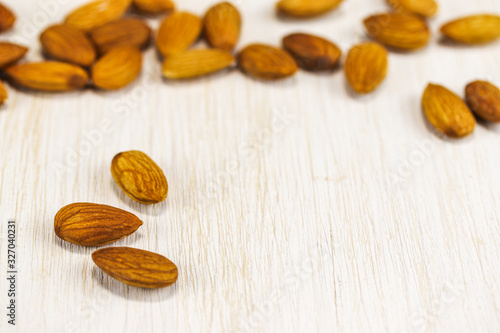 Almonds on a white wooden surface