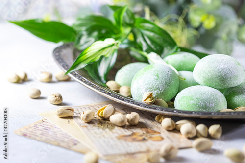 Japanese ice cream Mochi with pistachios in rice dough. Traditional Japanese dessert on white background.