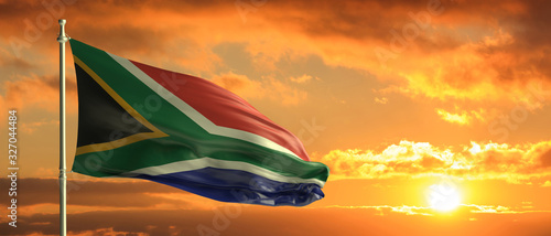 Photo South Africa flag waving on sunset sky background