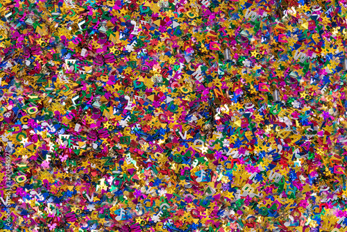Confetti close up, various colors and shapes of metallic confetti, horizontal background