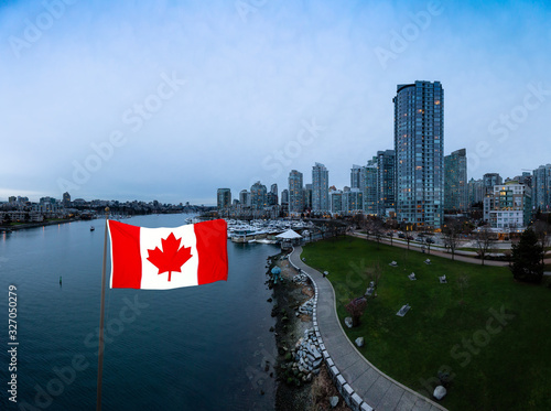 Canadian Flag. Downtown Vancouver, British Columbia, Canada. Beautiful Aerial Panoramic View of Modern City Buildings in False Creek during a colorful blue hour Sunset. Panorama