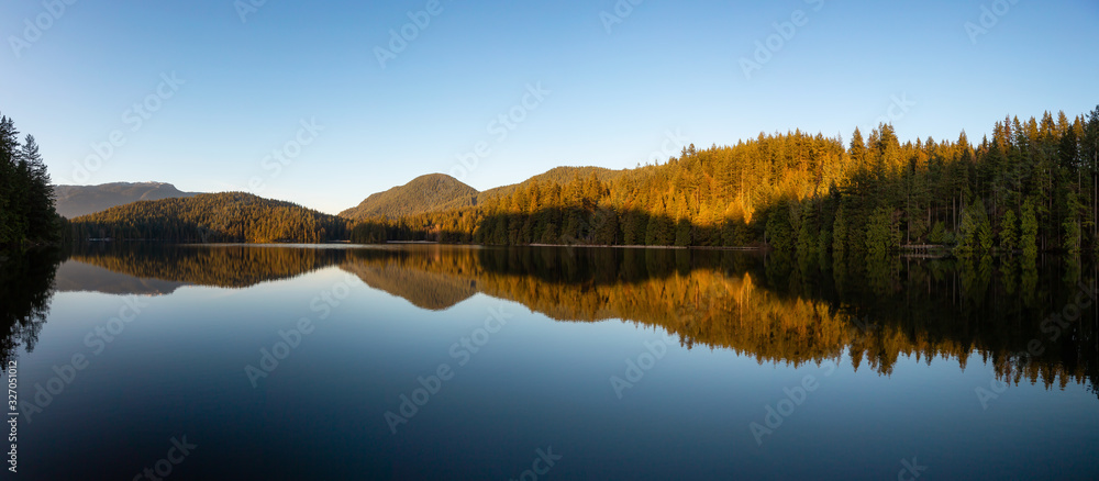 Beautiful and Vibrant panoramic view of a lake surounded by Canadian Mountain Landscape during sunset. Taken in White Pine Beach, Port Moody, Vancouver, British Columbia, Canada. Panorama