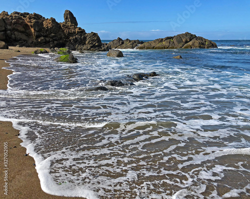 Foamy wave on beach at Fogarty Creek State Recreation Area in Oregon