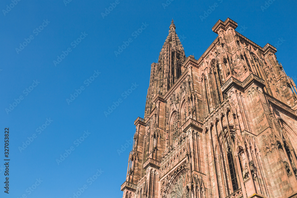 Facade and tower of Strasbourg Cathedral against the blue sky - copispace