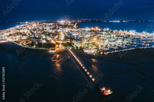 Aerial drone night view of Lignano Sabbiadoro, Italy. photo