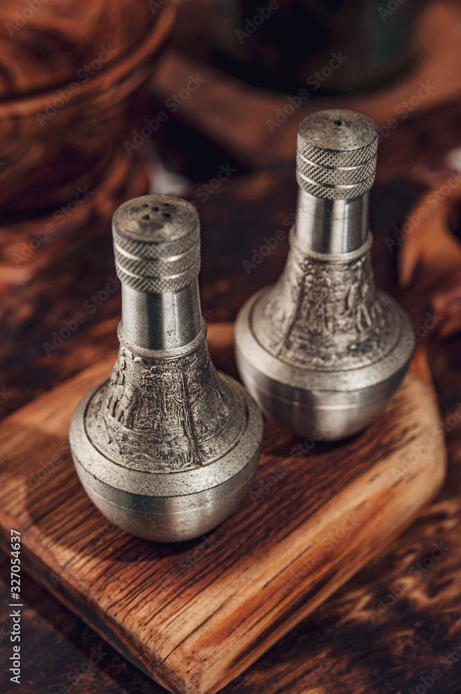 Bali salt and pepper shakers on the wooden board. Bali salt and pepper shakers on the wooden board.
