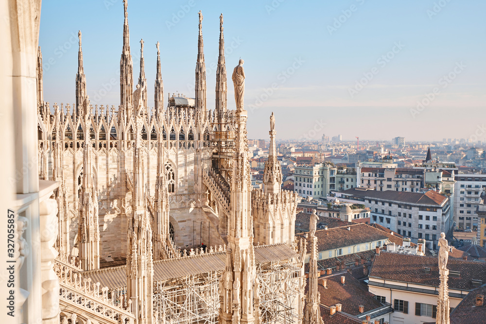 Amazing view of old Gothic spires. Milan Cathedral roof on sunny day, Italy. Milan Cathedral or Duomo di Milano is top tourist attraction of Milan.