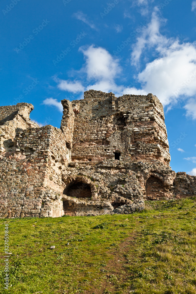 Tourists walk near the fortress of Yoros, Genoese fortress.