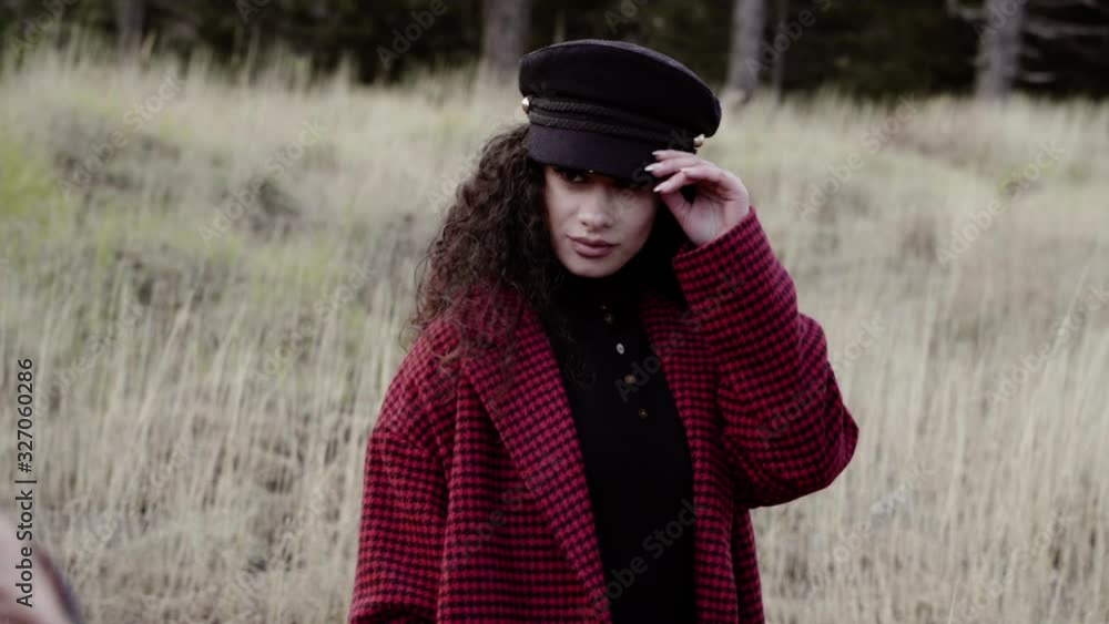 Pretty model with a red coat during a photographic backstage Pretty model with a red coat during a photographic backstage