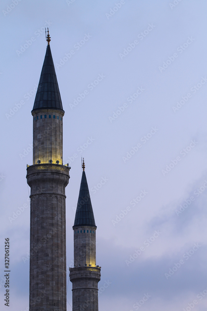 Two minarets on a background of blue morning sky. Islam.