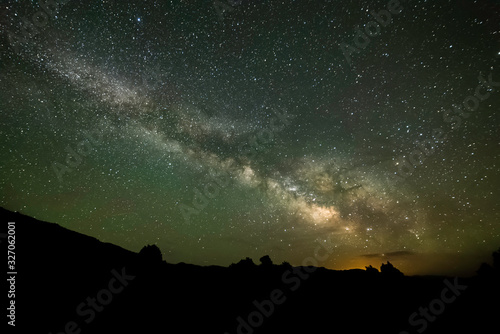 A brilliant view of the stars of the Milky Way Galaxy seen from Dark Night Skies North of Tonopah, Nevada, USA with the glow of Las Vegas on the horizon some 300 miles south.