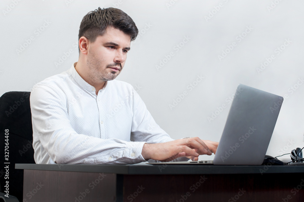 Handsome businessman working with laptop in office Handsome businessman working with laptop in office