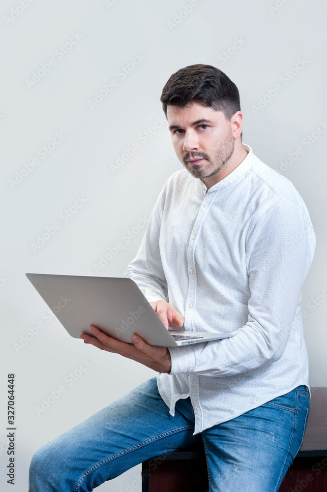 a young man with laptop in office