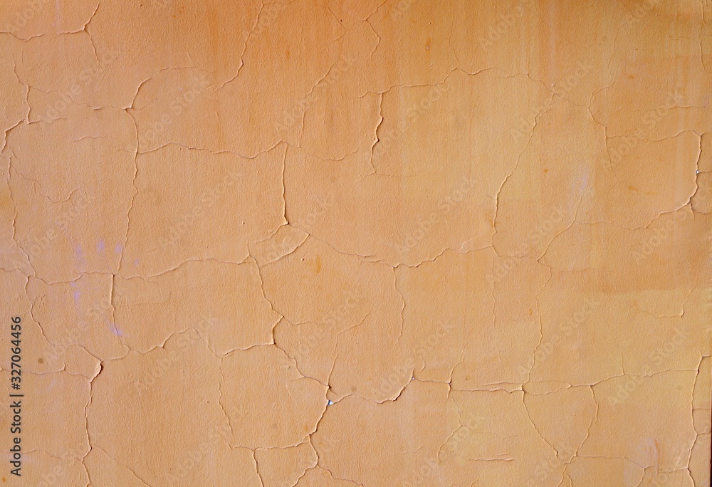 Yellow grunge cement wall, textured damaged background Yellow grunge cement wall, textured damaged background
