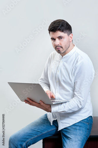 a young man with laptop in office