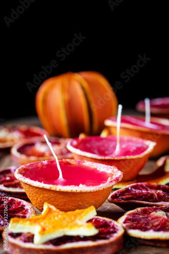 Christmas decoration with candle, dried oranges and cinnamon
