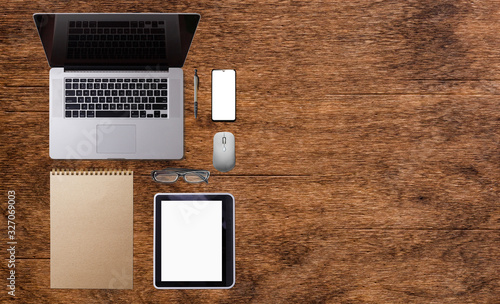 Wallpaper Mural Open laptop with digital tablet and white smartphone. All with isolated screen on old wooden desk. Torontodigital.ca