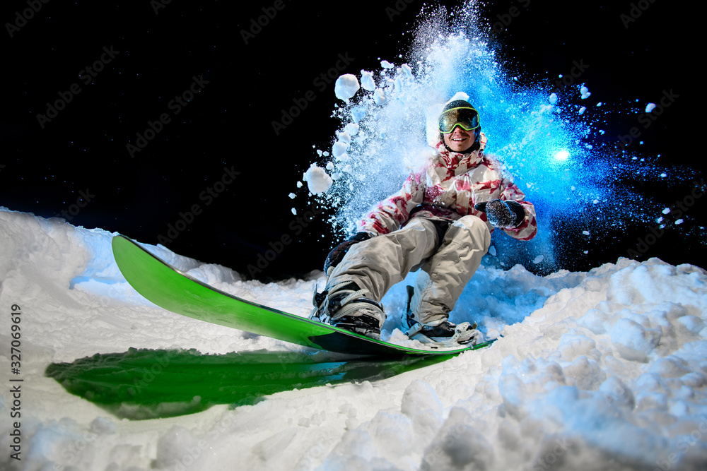 Fototapeta premium Man in winter clothes glides on a snowboard
