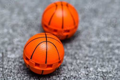 Two orange basketball like shoe freshener balls. Concept for avoiding unpleasant smell or odor from training shoes, sneakers and general footwear in an active lifestyle. photo