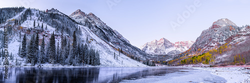 Maroon Bells morning sunrise panorama with sunlight on peak in Aspen, Colorado rocky mountain and autumn yellow foliage panoramic view winter snow photo
