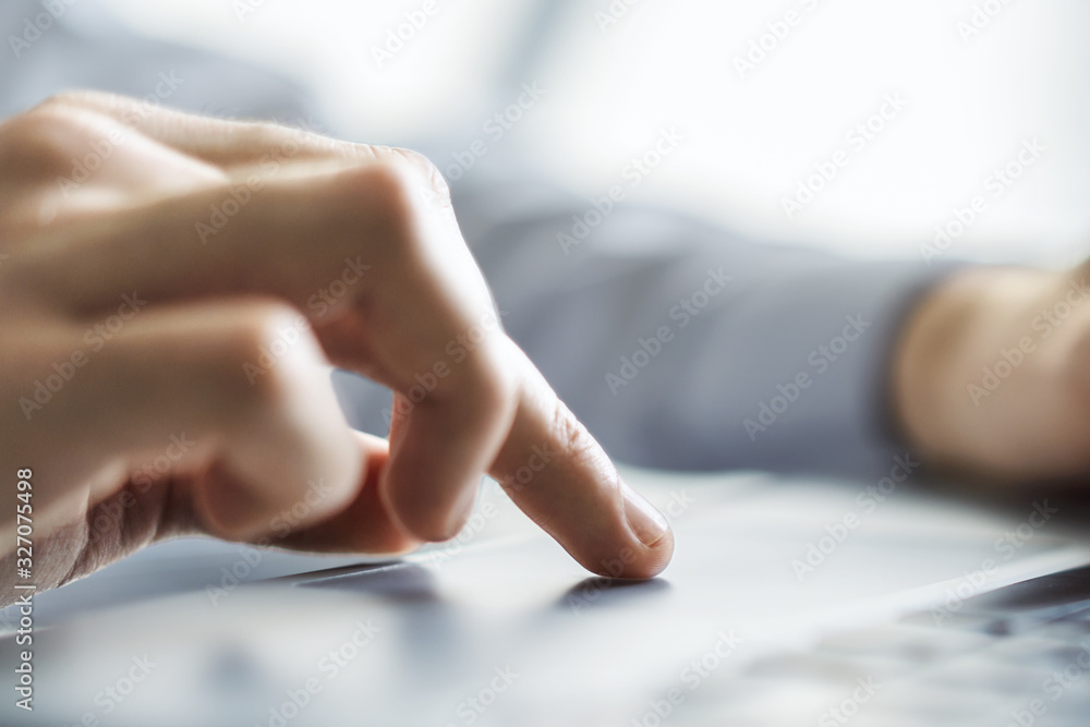 Man hands typing on laptop keyboard in sunny office, business and technology concept. Close up Man hands typing on laptop keyboard in sunny office, business and technology concept. Close up