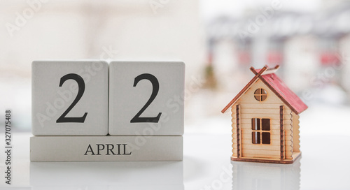 April calendar and toy home. Day 22 of month. Сard message for print or remember