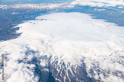Iceland high angle above view from airplane window with large glacier in south highlands near vik called tindfjallajokull, eyjafjallajokull and myrdalsjokull photo